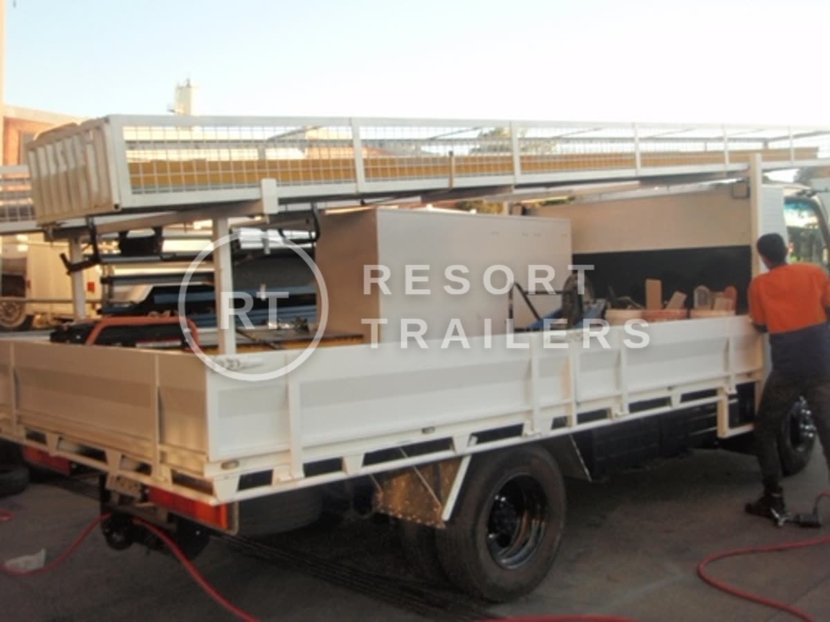 Custom roof racks and storage on transport truck — built by Resort Trailers